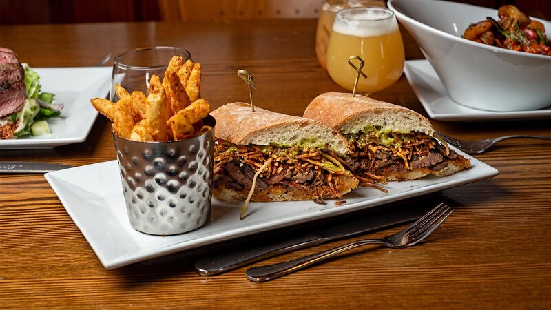 Flank steak sandwich with side of french fries